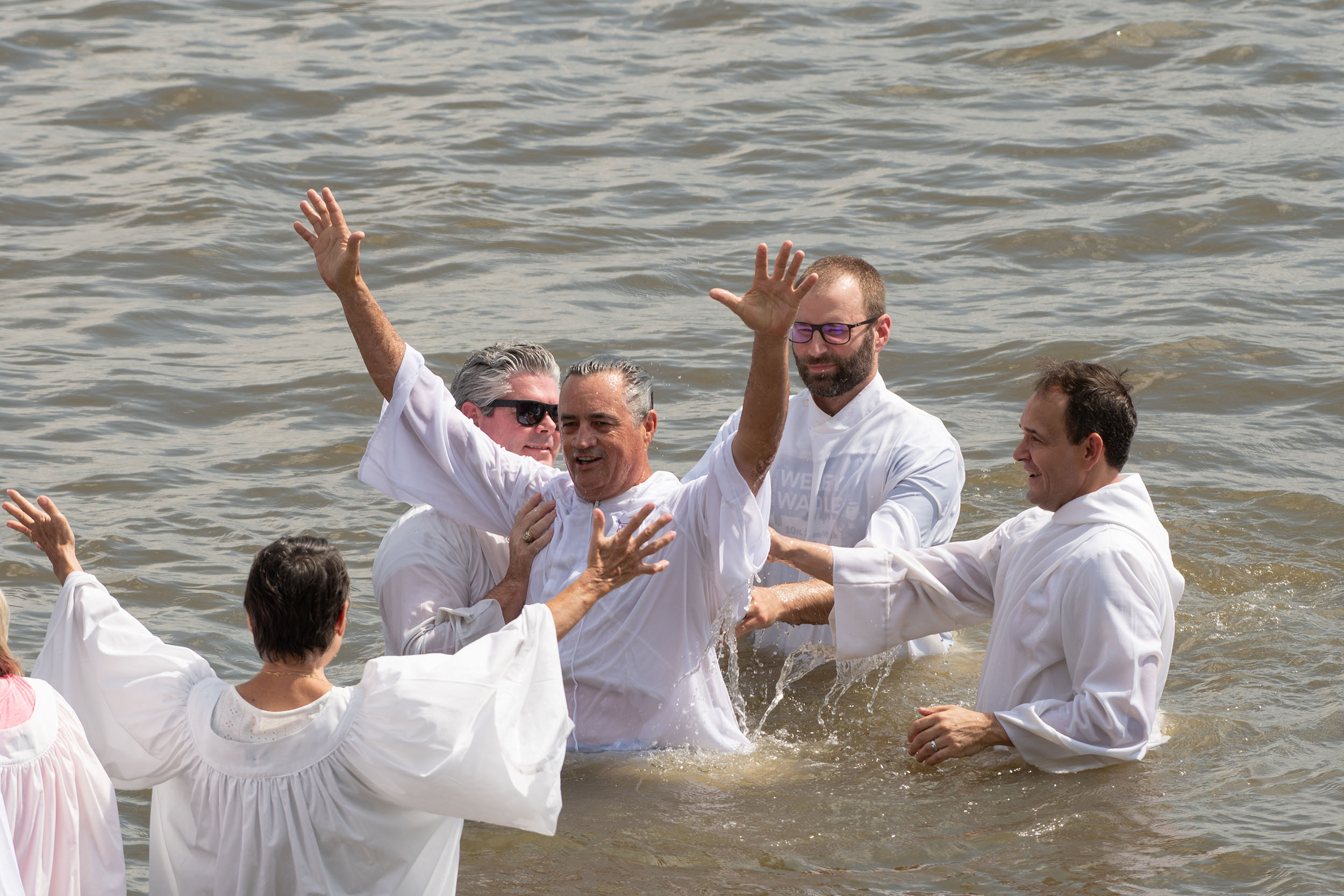 A river baptism being performed at The Church of the Cross